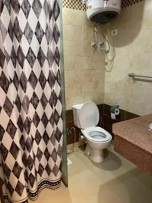 a bathroom with a toilet and a shower curtain at سيسليا بيتش ريزورت in Hurghada