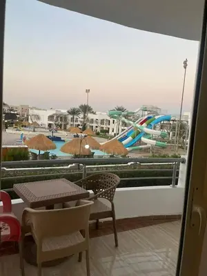 a balcony with a view of a water park at سيسليا بيتش ريزورت in Hurghada