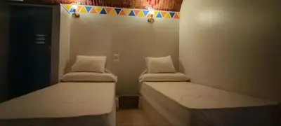 a small room with two beds in a room at Kemet Guest House in Aswan