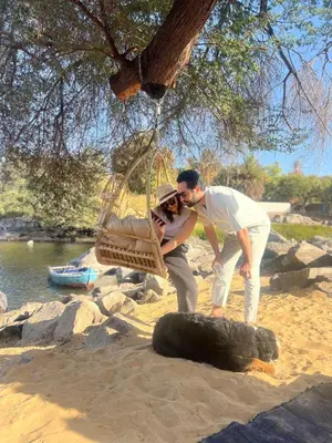 two people looking at a tire on the beach at Nala Narty Nubian House & Organic Farm in Aswan