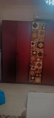 a room with two wooden cabinets with bears on the wall at Good place to enjoy vacation in Hurghada