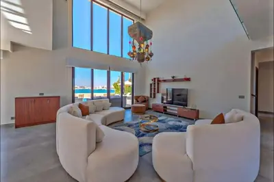 a living room with white furniture and a chandelier at inchant sands elgouna luxury villa in Hurghada