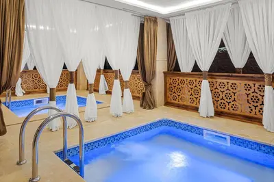 a swimming pool in a room with curtains at Albatros Makadi Resort - 24 HRS All Inclusive in Hurghada