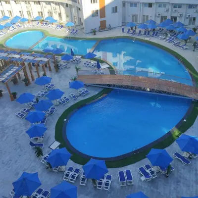 an overhead view of a pool with chairs and umbrellas at Golden Tayeb Hurghada Compound in Hurghada