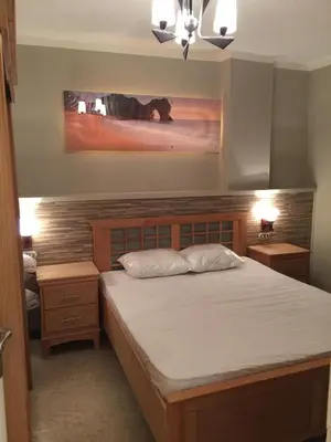 a bedroom with a large bed and two night stands at Cozy Apartment with Red Sea View in Hurghada