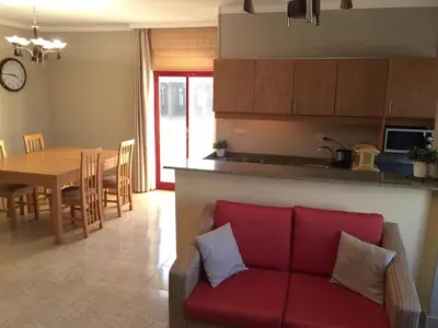 a living room with a red couch and a table at Cozy Apartment with Red Sea View in Hurghada