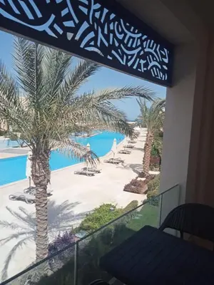 a view of the beach from the balcony of a resort at Pool & Sea View 2BR in Mangroovy in Hurghada
