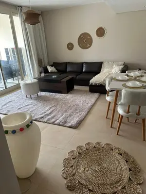 a living room with a couch and a table at Pool & Sea View 2BR in Mangroovy in Hurghada