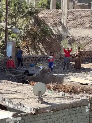a group of children standing in front of a building at Ezba Guest House in Luxor