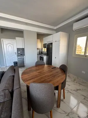 a living room with a wooden table and a couch at Seaside Serenity Apartment in Hurghada