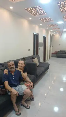 a man and a woman sitting on a couch at Gannet Alyousef City Center in Naj‘ al Maḩaţţah