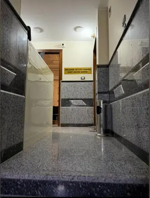 a hallway of a building with ailed floor at Gannet Alyousef City Center in Naj‘ al Maḩaţţah