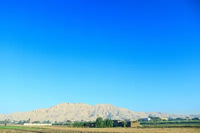a view of a field with mountains in the background at Holiday Dream Of Luxor in Luxor