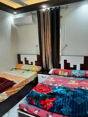 two beds in a room with two beds sidx sidx sidx at شقه سوبر لوكس in Hurghada