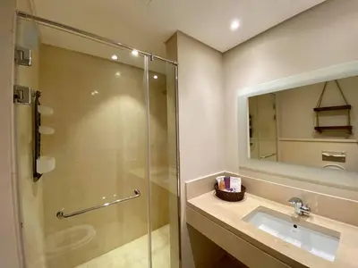 a bathroom with a glass shower and a sink at 2BR Mangroovy Ground floor in Hurghada