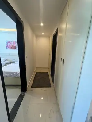 a hallway of a room with a bed and a mirror at Cozy one bedroom in a compound with beach ac in Hurghada