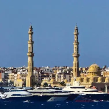 a group of boats in a harbor with mosques at Hurghada mit Charme in Hurghada