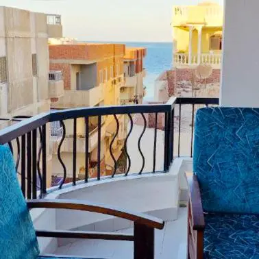 a balcony with a chair and a view of the ocean at Hurghada mit Charme in Hurghada
