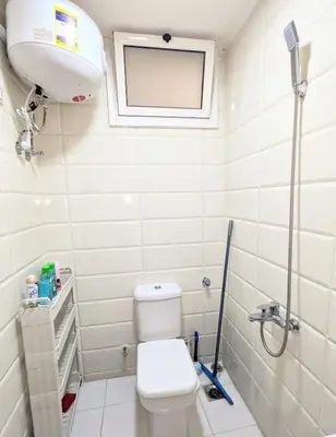 a small bathroom with a toilet and a window at Fanta Sea Studio with private jacuzzi - Al Ahyaa in Hurghada