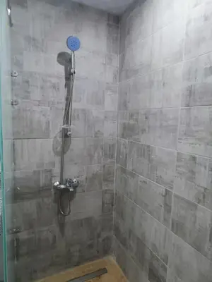 a shower with a shower head in a bathroom at Vitamin Sea, Beach Front Central Free Wi-Fi in Hurghada