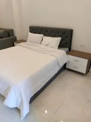 a bedroom with a large bed with white sheets at الغردقه in Hurghada
