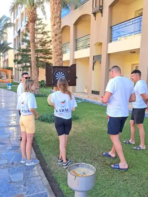 a group of people standing outside of a building at Studio in elkarma resort & aqua park in Hurghada