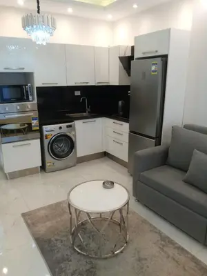 a kitchen with a couch and a table in a room at Hurghadiansrealty in Hurghada
