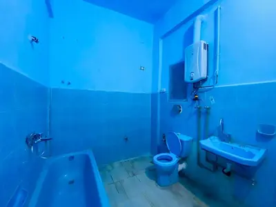 a blue bathroom with a toilet and a sink at Pharaoh apartment 2 in Luxor