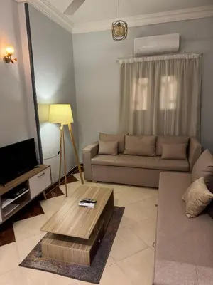 a living room with a couch and a coffee table at Cozy Retreat by The Sea in Safaga