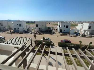 a view of a parking lot with white buildings at Stay at elgouna with private heated pool villa in Hurghada
