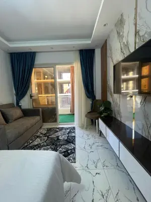 a hotel room with a bed and a couch at Oscar luxury N109Free WI-FI in Hurghada