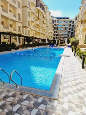 a large swimming pool in front of some apartment buildings at Oscar luxury N109Free WI-FI in Hurghada