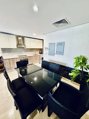 a dining room with a black table and chairs at 2 Bedrooms Ground Floor Pool view in Mangroovy Residence in Hurghada