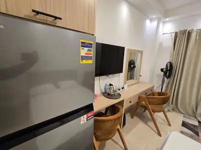 a kitchen with a refrigerator and a desk with a computer at Florenza Khamsin bird in Hurghada