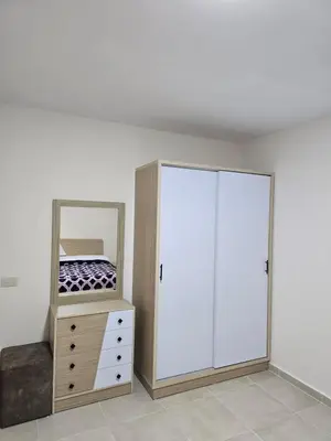 a bedroom with a dresser and a mirror at Tiba Golden Down Town in Hurghada