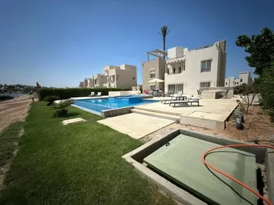 a swimming pool in a yard next to a building at Luxury villa in gouna in Hurghada