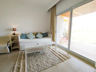 a living room with a couch and a large window at Tranquil escape in Hurghada