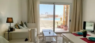 a living room with a view of a pool at Tranquil escape in Hurghada