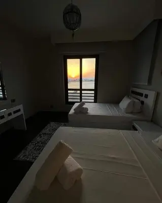 a bedroom with two beds and a view of the ocean at Luxury villa in gouna in El Gouna