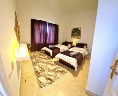 a bedroom with two beds and a large rug at White villa in Hurghada
