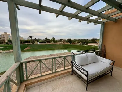 a porch with a chair and a view of a golf course at G20-1-5 El golf in Hurghada