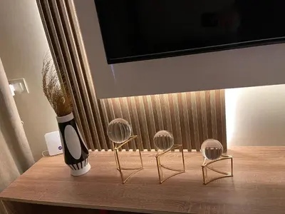 a vase and two chairs on a table with a tv at Hurghada Stylish Heaven Luxury Apartment in Hurghada