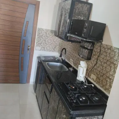 a small kitchen with a sink and a stove at Golden Tayeb Hurghada Compound in Hurghada