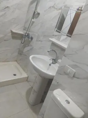 a bathroom with a sink and a toilet and a mirror at Golden Tayeb Hurghada Compound in Hurghada