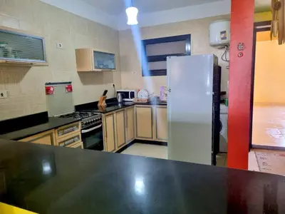 a kitchen with a stainless steel refrigerator in it at Esplanadа Apartments in Hurghada