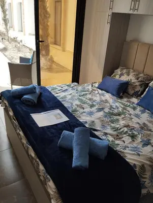 a bed with two blue towels on top of it at Studiowohnung Aqua Infinity in Hurghada