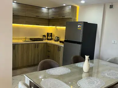 a kitchen with a table and a refrigerator at Hurghada Fanadir Bay in Hurghada