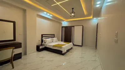 a bedroom with a bed and a mirror in it at Prestige Residency in Hurghada