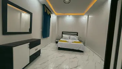 a bedroom with a bed with a mirror and a dresser at Prestige Residency in Hurghada
