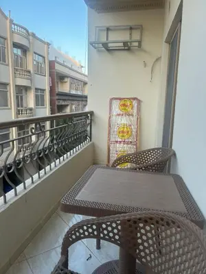 a balcony with a table and chairs on a balcony at H&H Twin Apartment in Hurghada